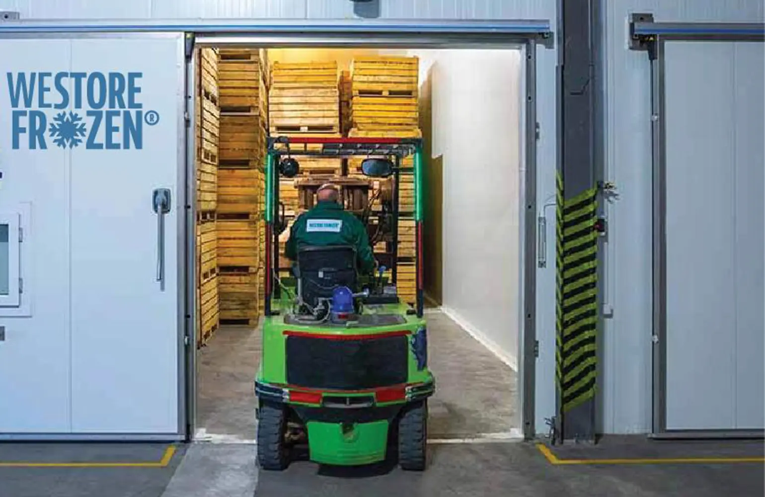 Frozen storage warehouse interior with racking, cooling units, and clear aisles